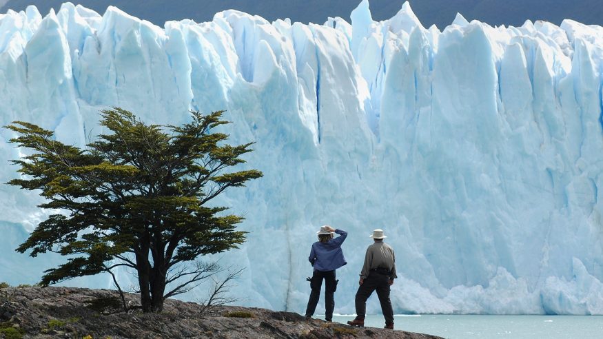 Calafate, Patagonia, Argentina - December, 7th 2004:tourists stand on a hill overlooking the Perito Moreno Glacier in Patagonia