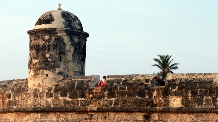 Cartagena_woman relaxing on fortress wall