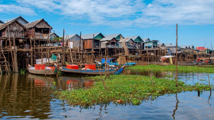 Simple bamboo houses built in the water of Tonle Sap Lake near Siem Reap in Cambodia