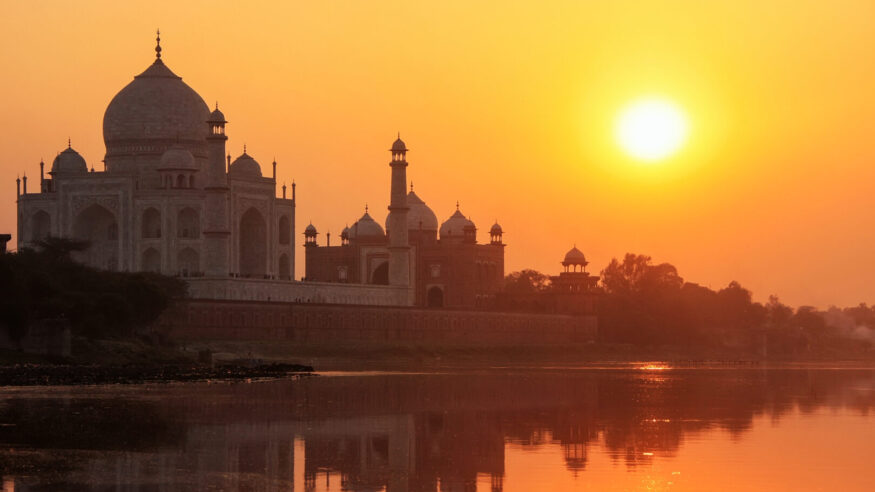 Taj Mahal reflected in the Yamuna river at sunset 