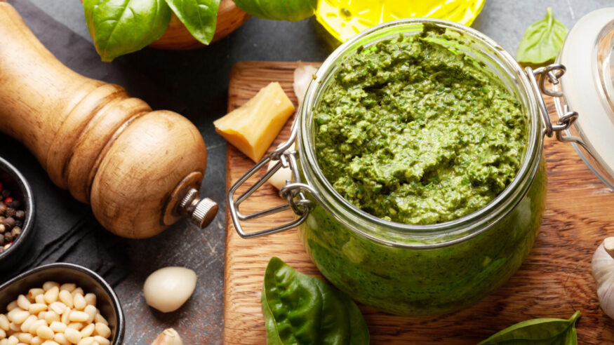 Homemade pesto sauce with basil leaves, pine nuts, parmesan and garlic